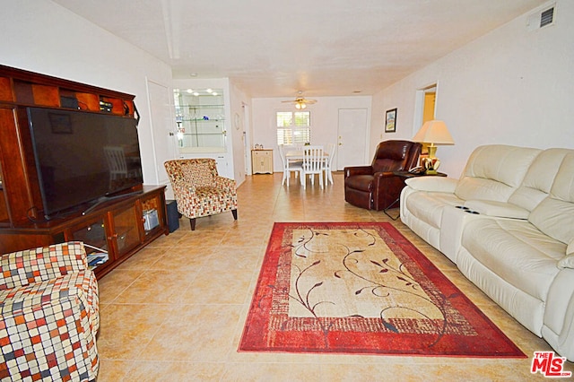 living room with ceiling fan and light tile patterned flooring