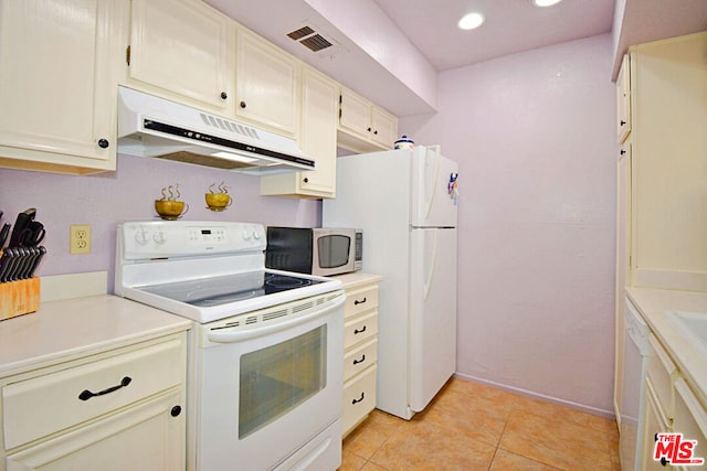 kitchen with white appliances and light tile patterned floors