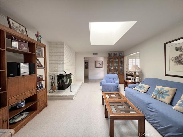 carpeted living room featuring a wood stove and a skylight