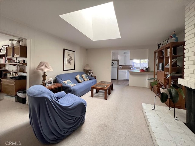 carpeted living room featuring a skylight