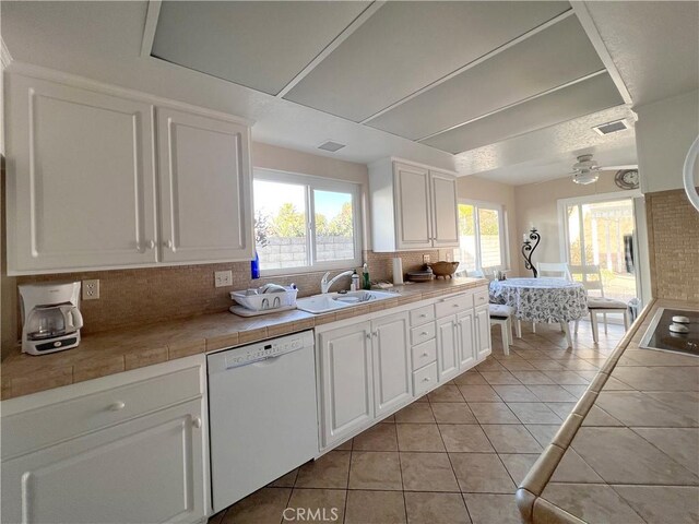 kitchen featuring white cabinetry, white dishwasher, decorative backsplash, and sink