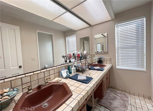 bathroom with tile patterned flooring and vanity