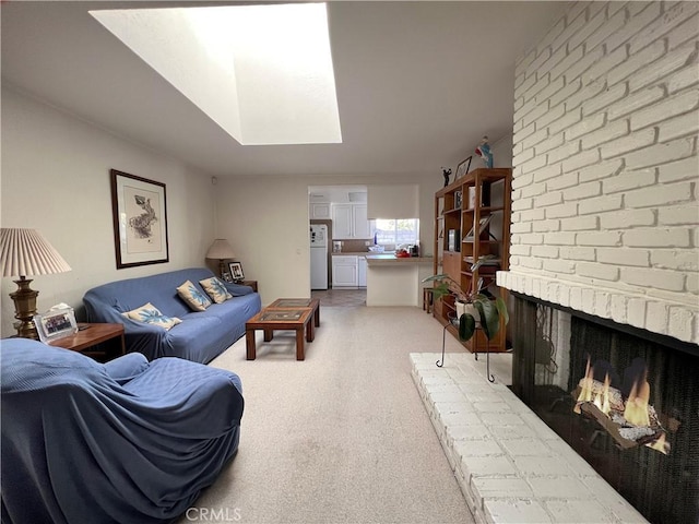 living room with light carpet, a brick fireplace, and a skylight