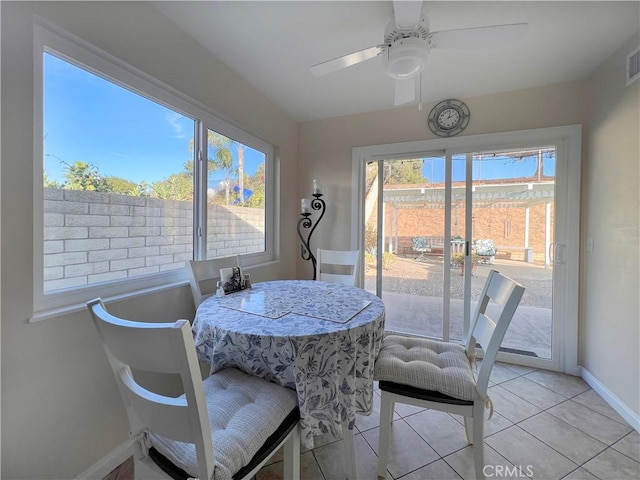 dining area featuring ceiling fan and light tile patterned floors