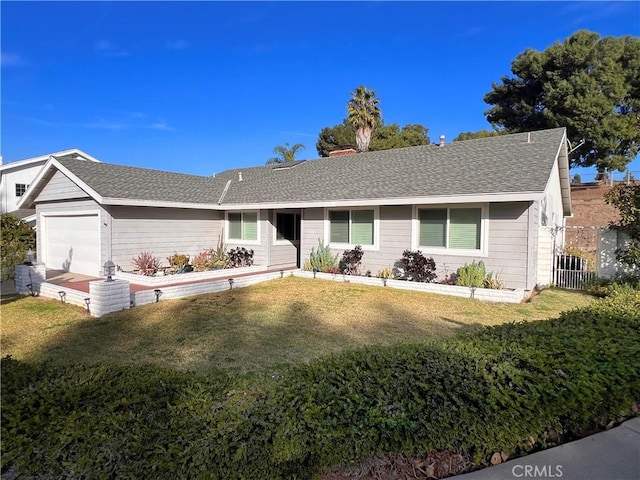 ranch-style home with a garage and a front lawn