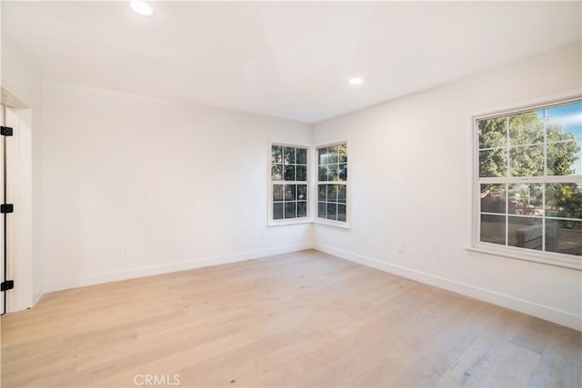 spare room with light wood-type flooring