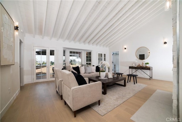 living room featuring high vaulted ceiling, light hardwood / wood-style flooring, and beamed ceiling