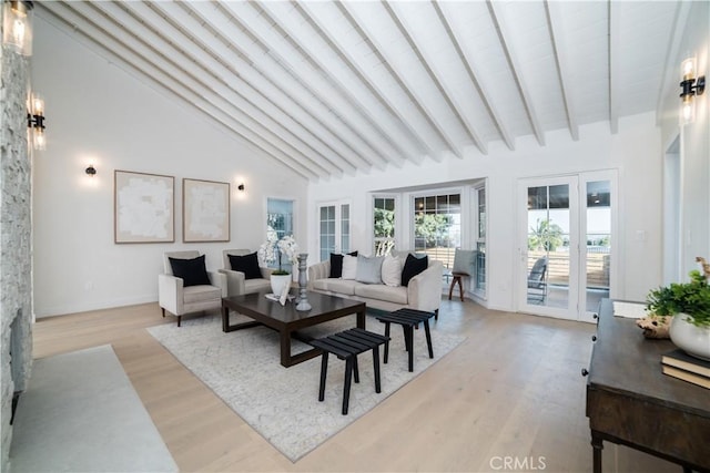 living room featuring high vaulted ceiling, beam ceiling, light wood-type flooring, and french doors