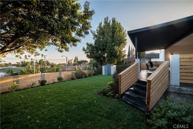 yard at dusk with a storage unit