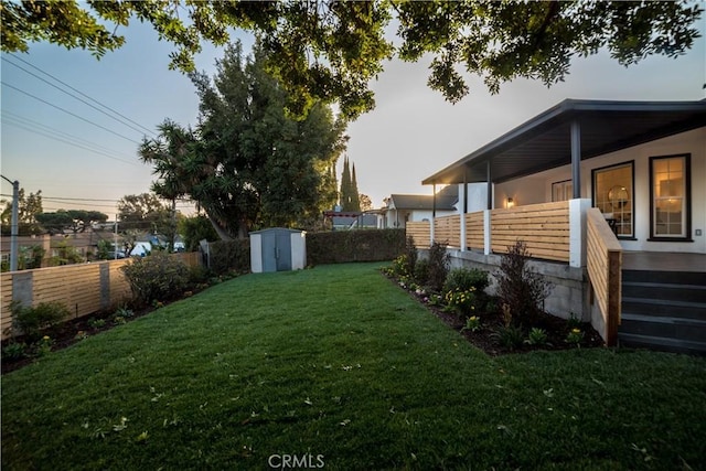 yard at dusk with a storage unit