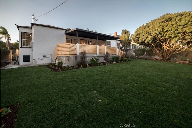 rear view of house with a lawn