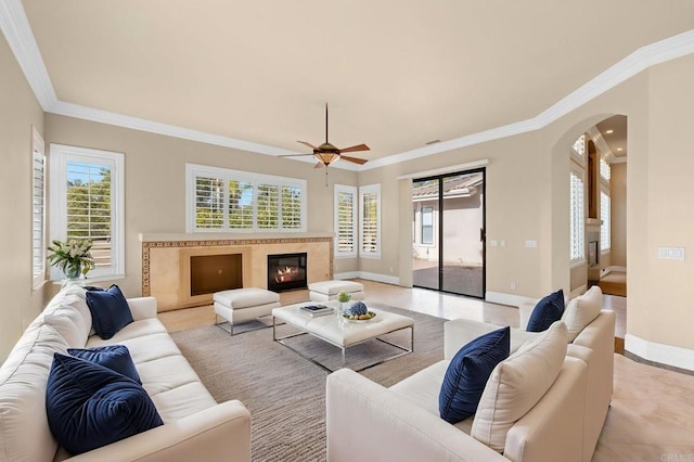 tiled living room featuring a wealth of natural light and crown molding