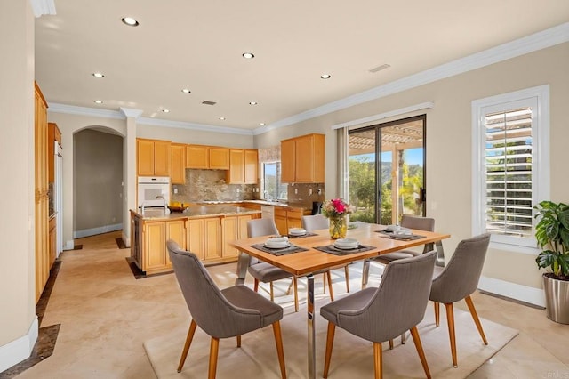 dining room featuring light tile patterned floors and ornamental molding