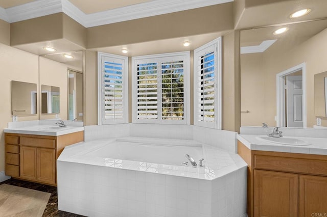 bathroom with ornamental molding, tiled tub, and vanity