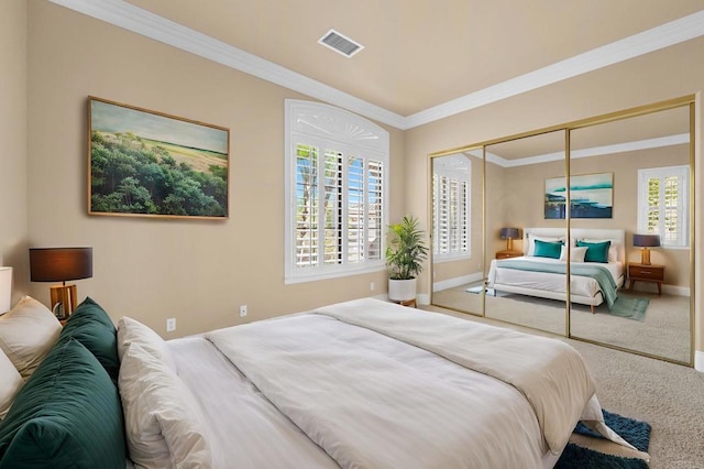 carpeted bedroom featuring multiple windows, a closet, and ornamental molding