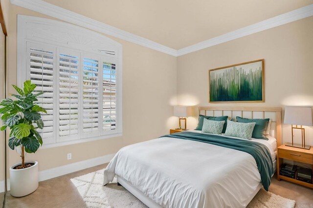 carpeted bedroom featuring crown molding