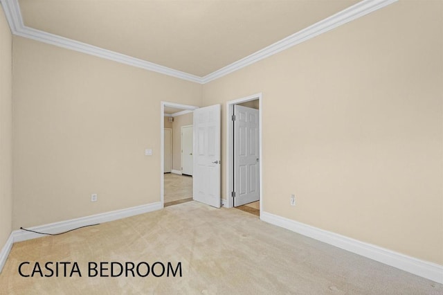 unfurnished bedroom featuring ornamental molding and carpet flooring