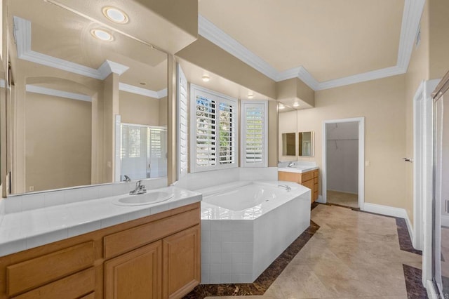 bathroom with tiled tub, vanity, and crown molding