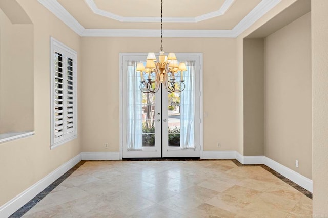 unfurnished dining area featuring french doors, crown molding, a raised ceiling, and a notable chandelier