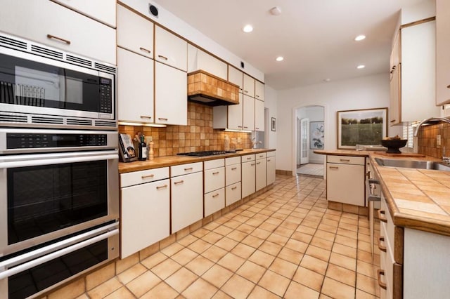 kitchen featuring white cabinetry, appliances with stainless steel finishes, and sink