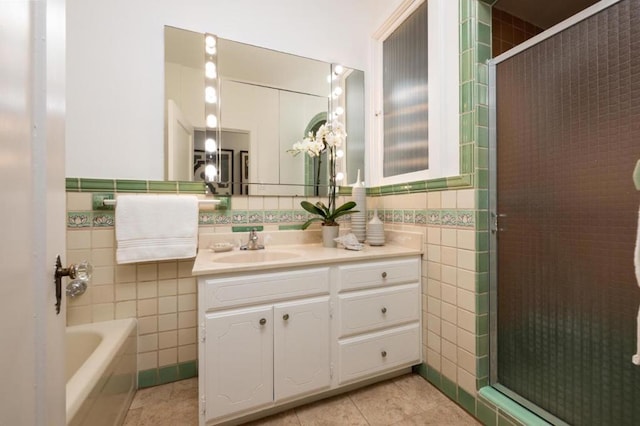 bathroom with vanity, shower with separate bathtub, tile patterned flooring, and tile walls