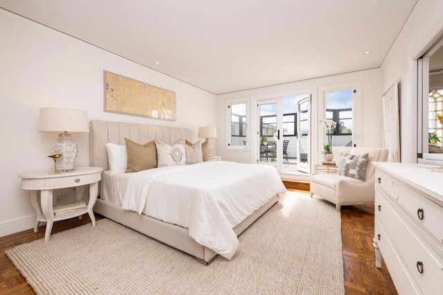 bedroom featuring multiple windows and light parquet floors