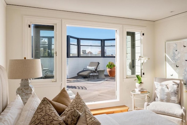 doorway to outside with hardwood / wood-style flooring, ornamental molding, and a healthy amount of sunlight