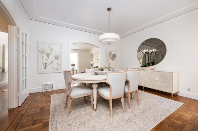 dining space featuring dark parquet floors