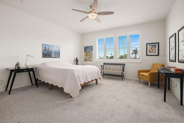 bedroom featuring light carpet and ceiling fan