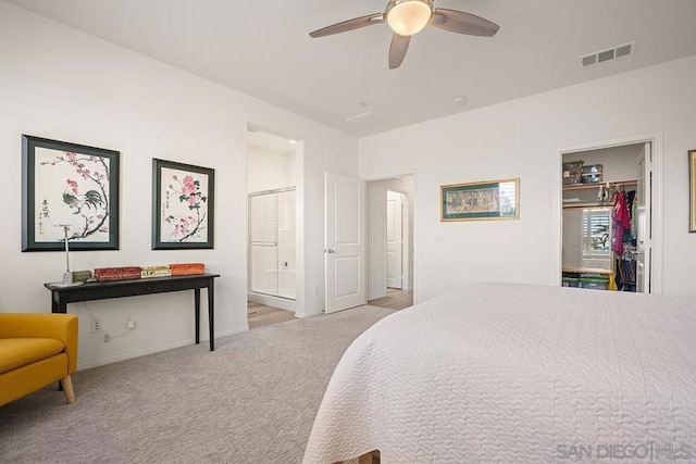 carpeted bedroom with ceiling fan and a closet