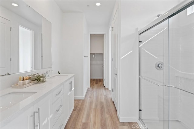 bathroom with vanity, hardwood / wood-style floors, and walk in shower