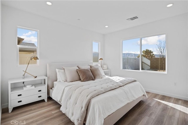 bedroom with dark hardwood / wood-style floors