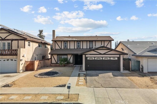 tudor-style house featuring a garage