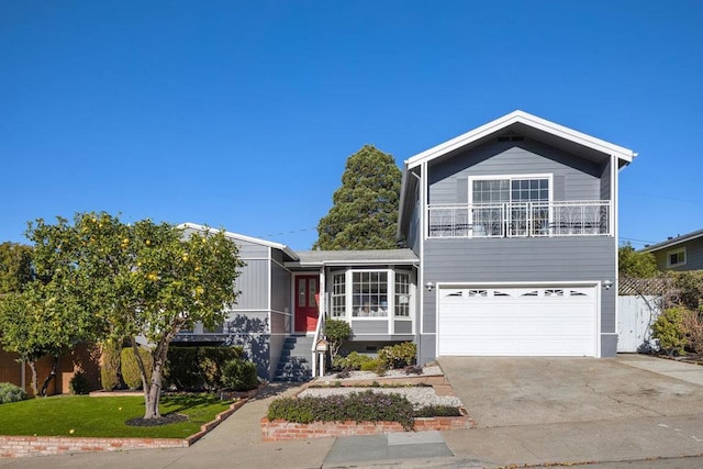 view of front of property featuring a front yard, a balcony, and a garage