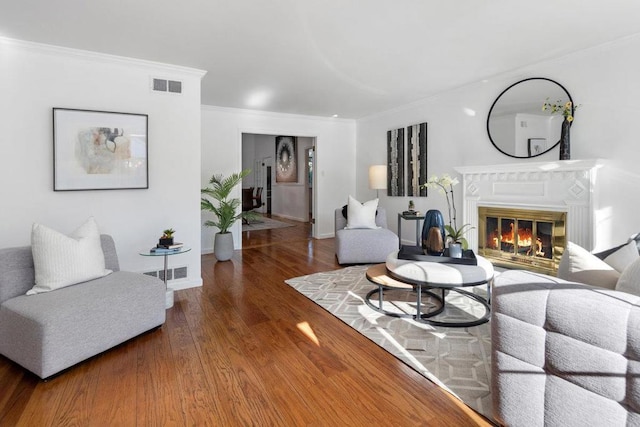 living room with ornamental molding and dark hardwood / wood-style flooring