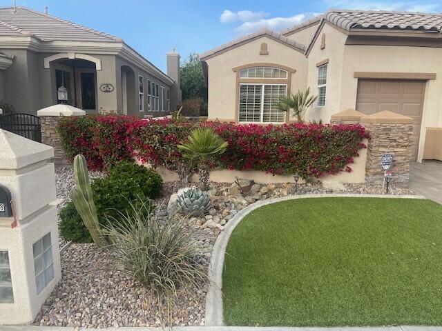 view of side of property with a garage and a yard