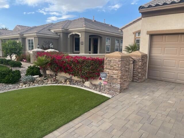 view of front of home with a front lawn and a garage