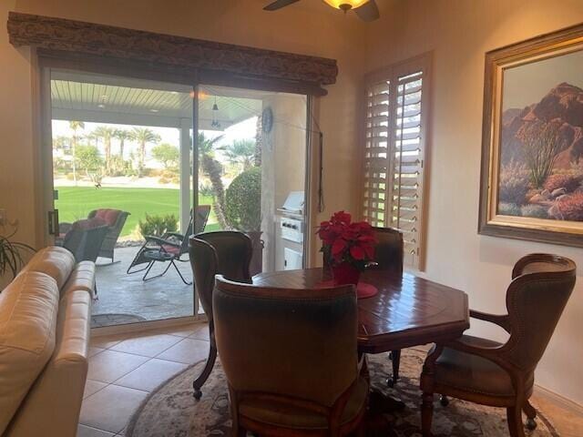 tiled dining area with ceiling fan