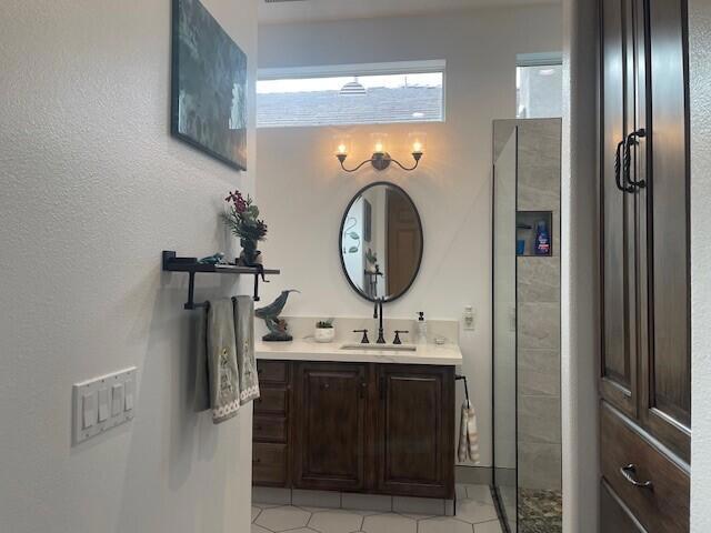 bathroom with walk in shower and vanity