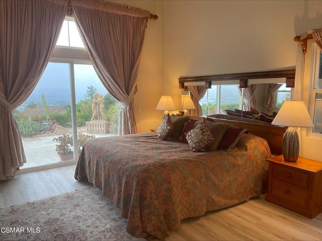 bedroom featuring light wood-type flooring and access to exterior