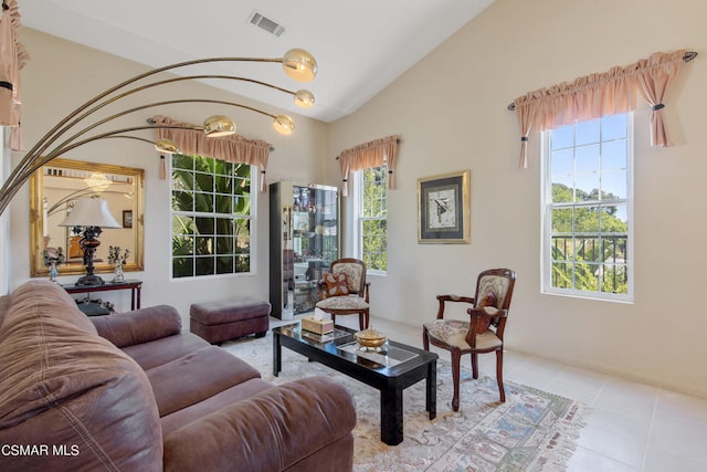 living area with light tile patterned floors and vaulted ceiling