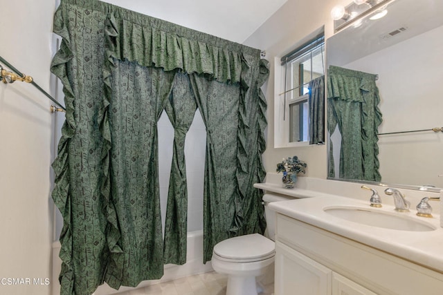 full bathroom with toilet, vanity, and shower / tub combo with curtain