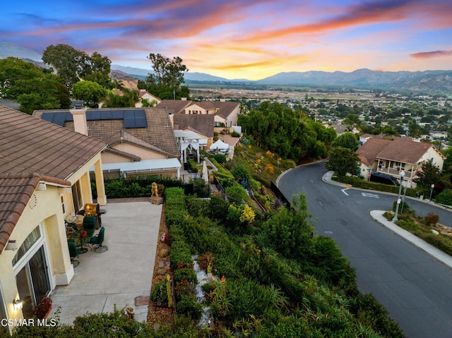 aerial view at dusk featuring a mountain view