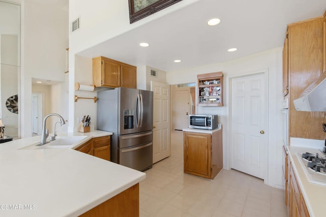 kitchen with stainless steel appliances, kitchen peninsula, and sink