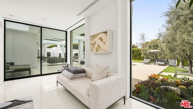 living area featuring floor to ceiling windows