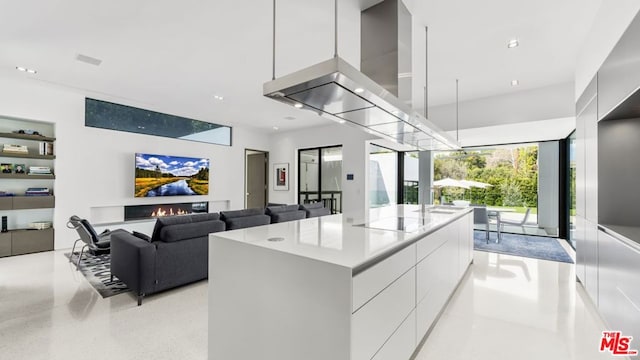 kitchen with white cabinetry, a center island, and extractor fan