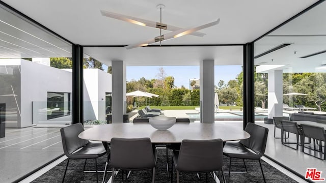 dining area featuring floor to ceiling windows