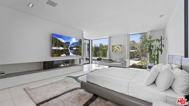 bedroom featuring floor to ceiling windows