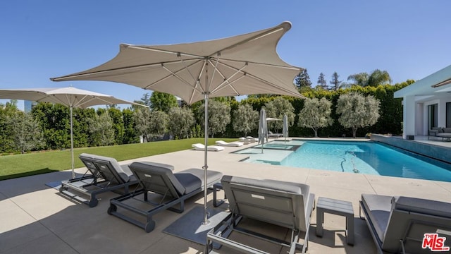 view of pool featuring a yard and a patio