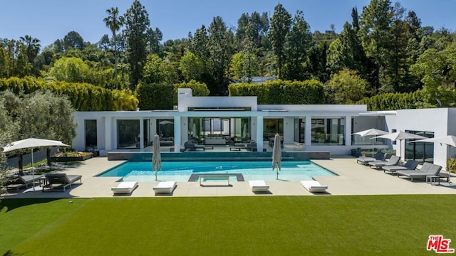 rear view of house with an outdoor hangout area, a patio area, and a yard